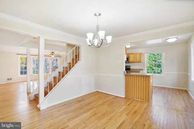 a kitchen with stainless steel appliances granite countertop a sink and a refrigerator