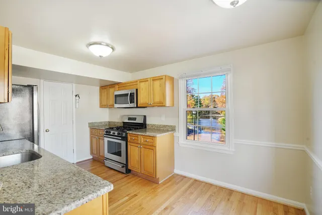a kitchen with stainless steel appliances a stove a microwave and cabinets