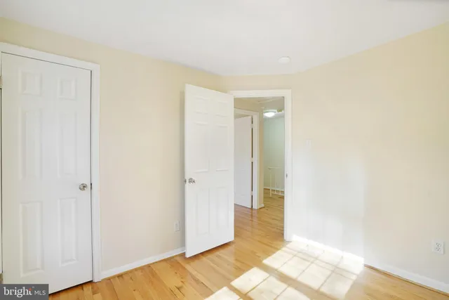 a view of a brick house next to a yard with potted plants
