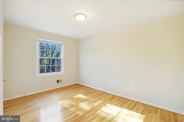 a view of a backyard with wooden fence