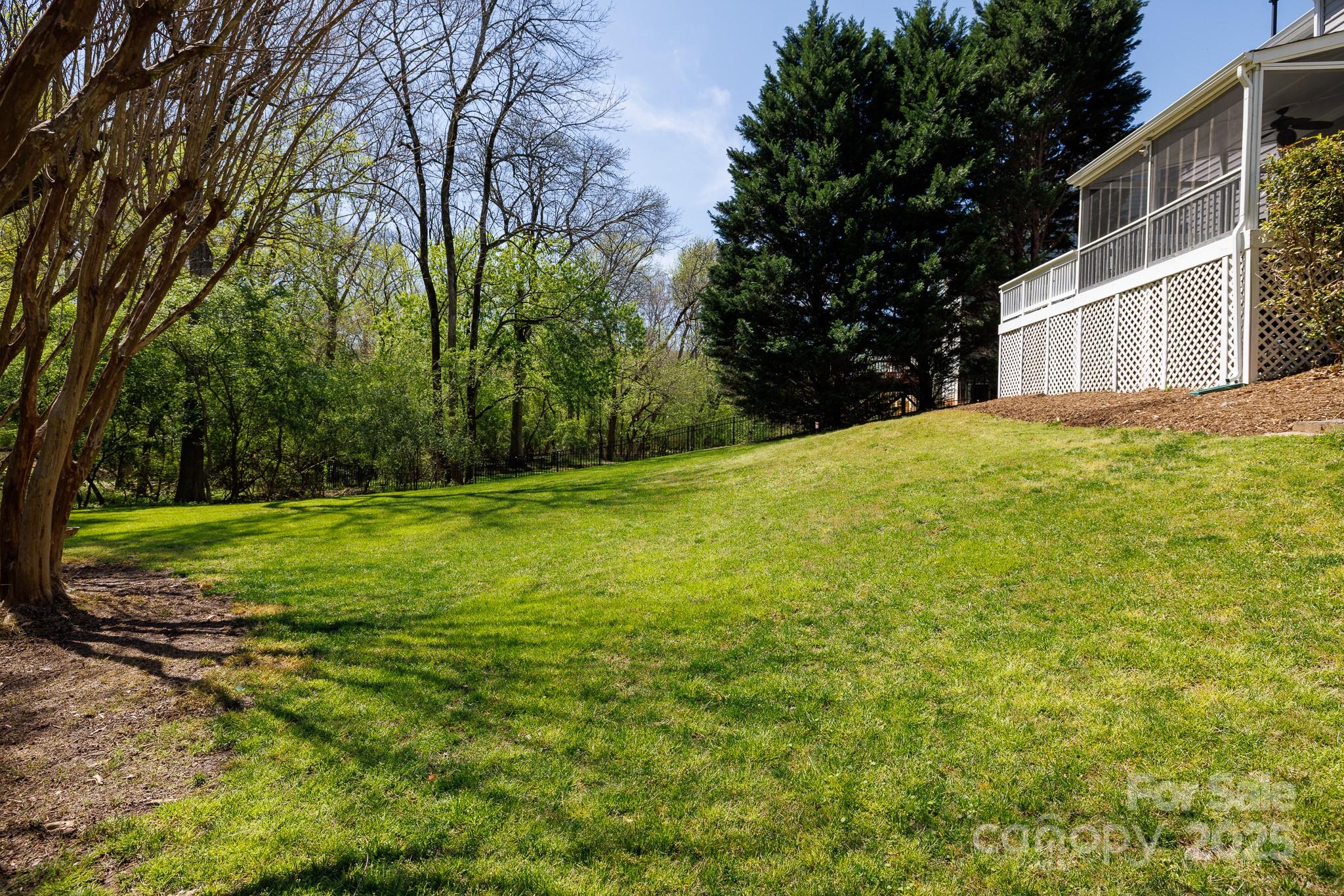 2815 Providence Spring Lane Charlotte, NC 28270 - Photo 34 of 42 a view of a yard with a house and large trees