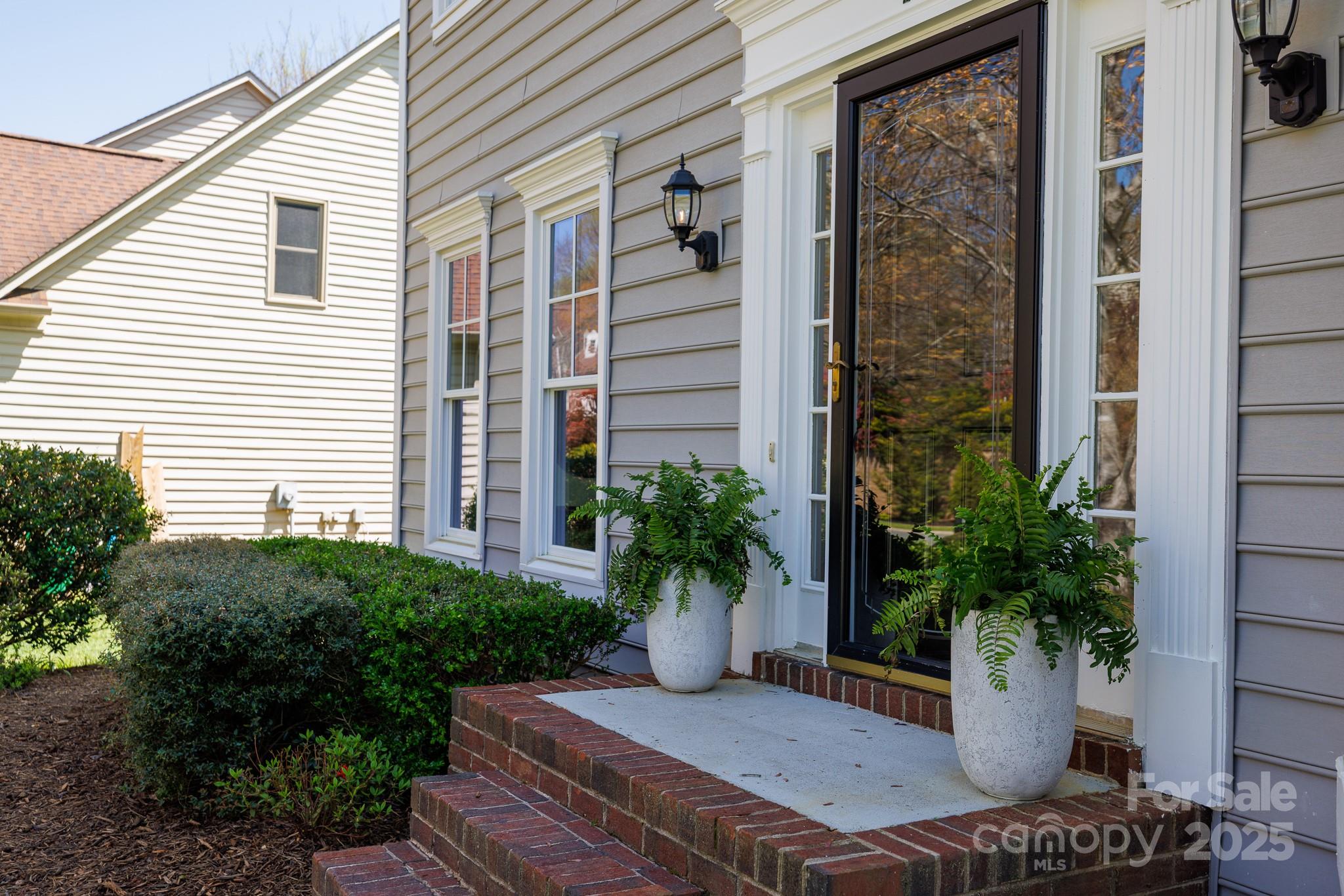 2815 Providence Spring Lane Charlotte, NC 28270 - Photo 5 of 42 a view of a balcony with chair and potted plants