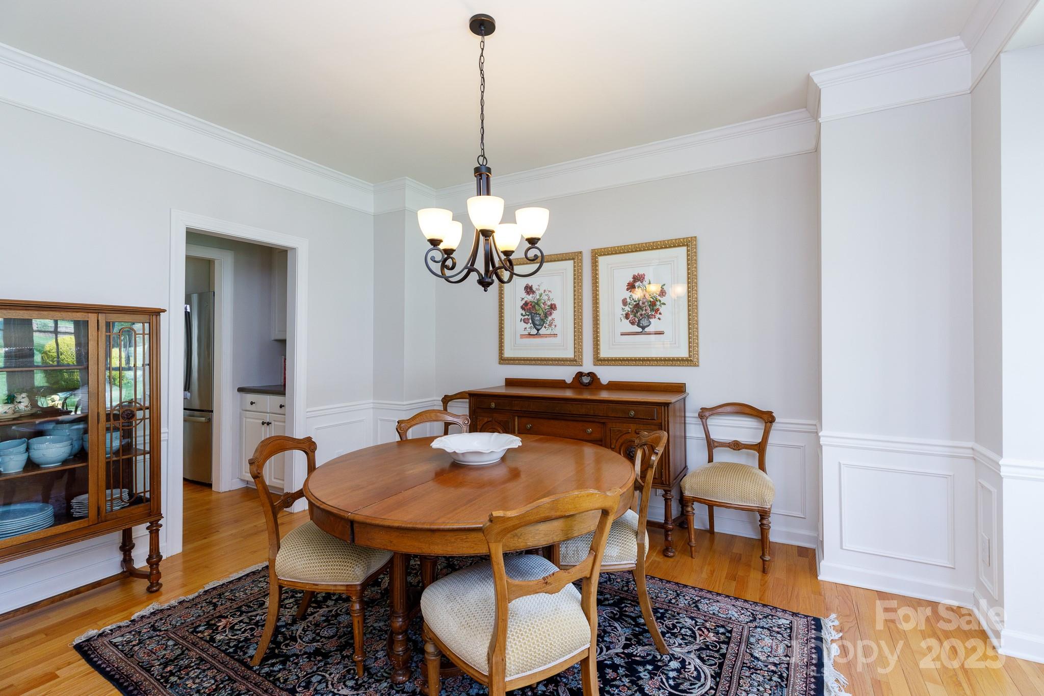2815 Providence Spring Lane Charlotte, NC 28270 - Photo 7 of 42 a dining room with furniture a rug and a chandelier