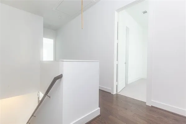 a view of hallway with wooden floor