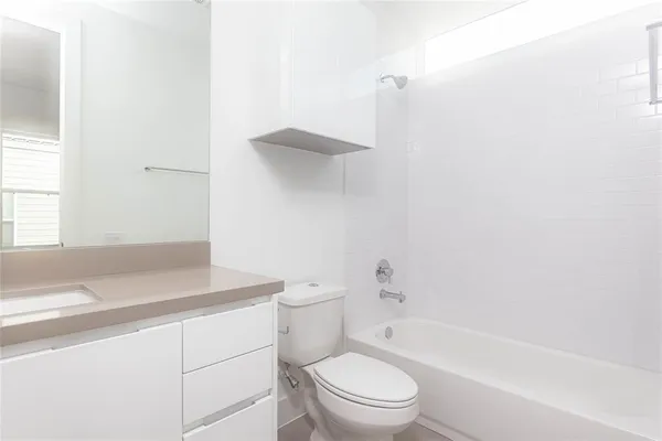 a bathroom with a toilet a sink and a bathtub