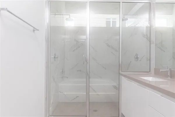 a bathroom with a shower and a sink