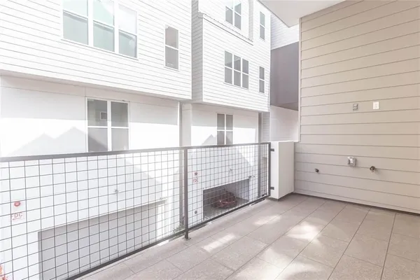 a view of a brick house with white walls