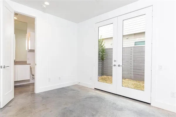 a view of an empty room with glass door