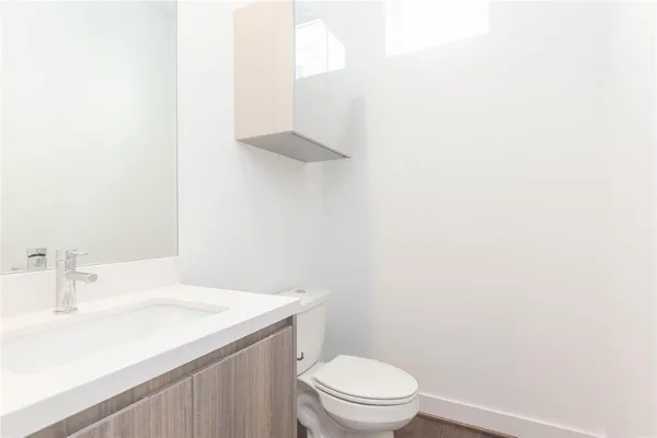 a bathroom with a sink a toilet and vanity