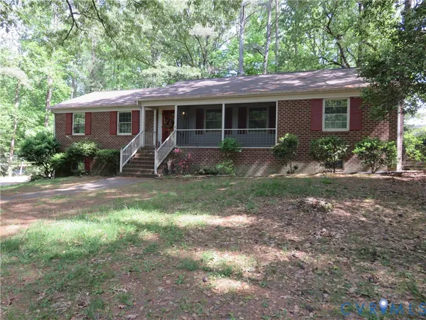 a front view of house with yard and outdoor seating