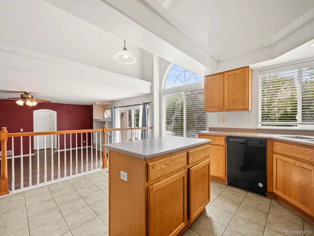 a view of a livingroom with wooden floor and a ceiling fan