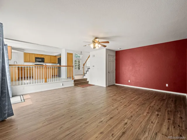 a spacious bedroom with a bed a couch and potted plant