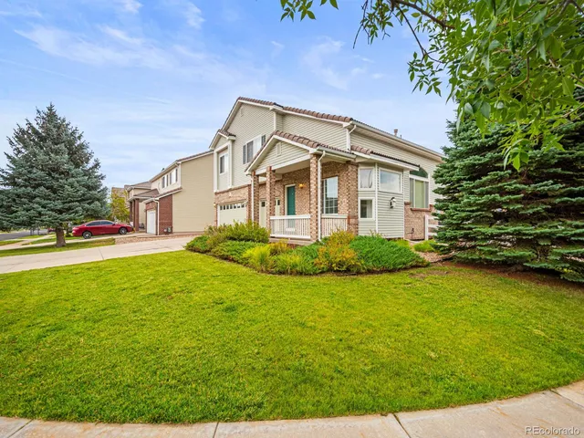 a living room with fireplace furniture and a wooden floor