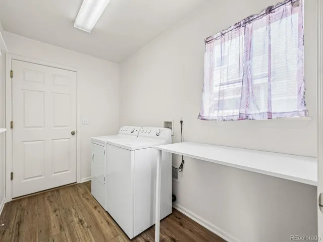 an empty room with chandelier fan and windows