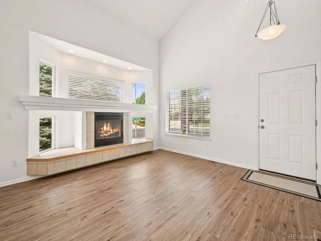 a view of a livingroom with wooden floor and a window