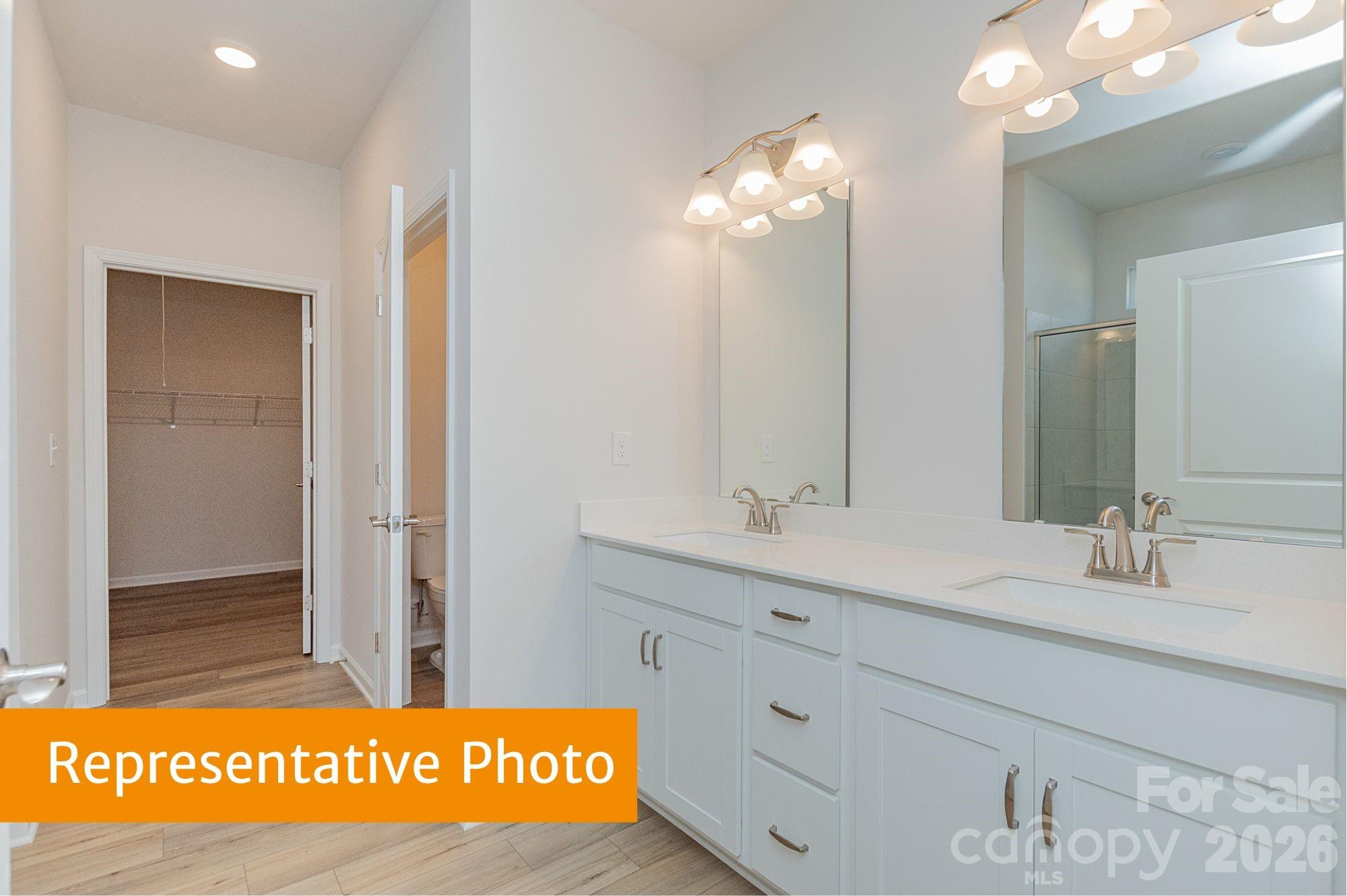 6352 Busch Way Midland, NC 28107 - Photo 13 of 27 a bathroom with a sink a mirror and a shower