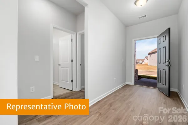 a view of hallway with wooden floor
