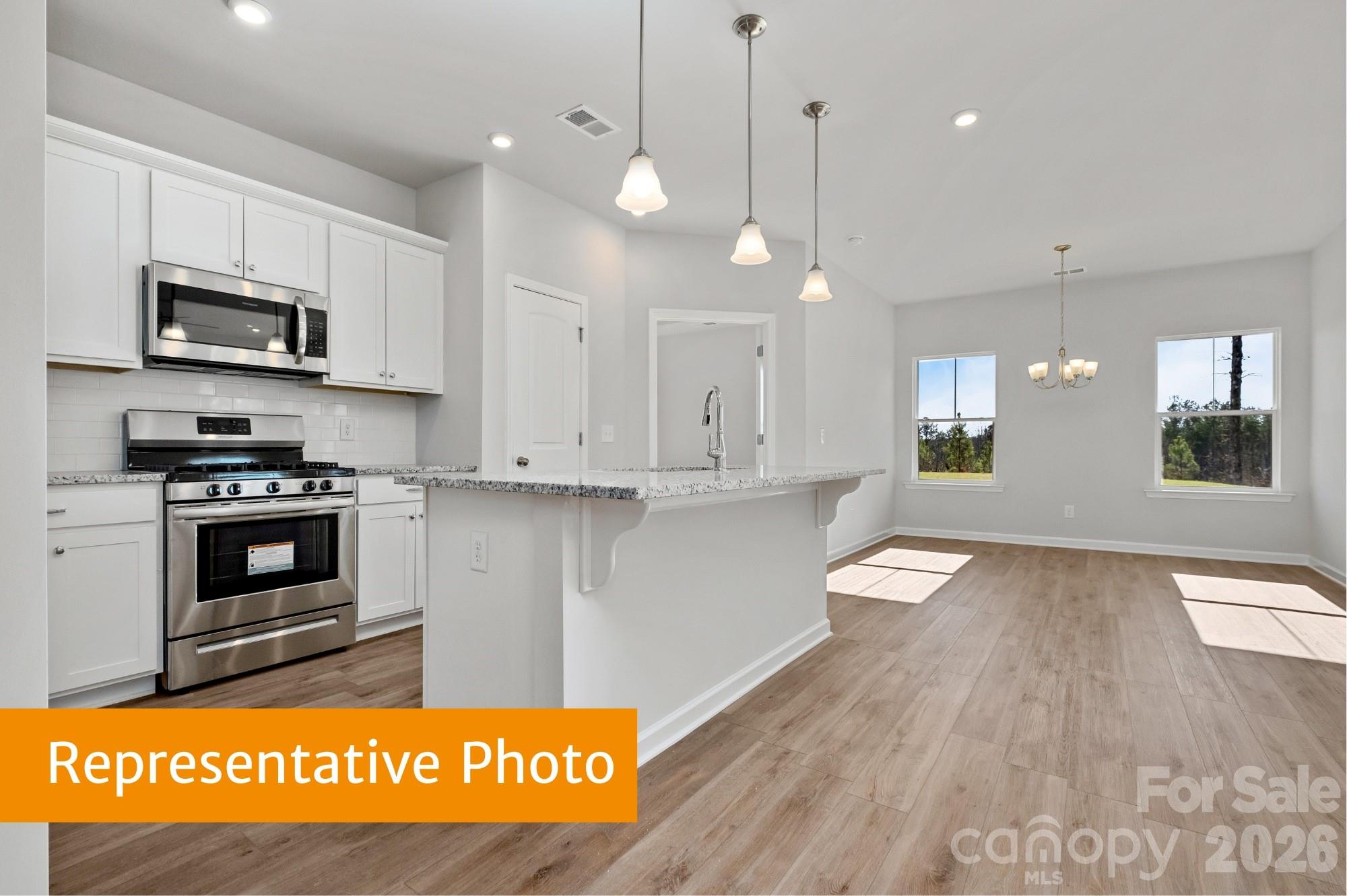 6352 Busch Way Midland, NC 28107 - Photo 3 of 27 a view of kitchen with stove and microwave