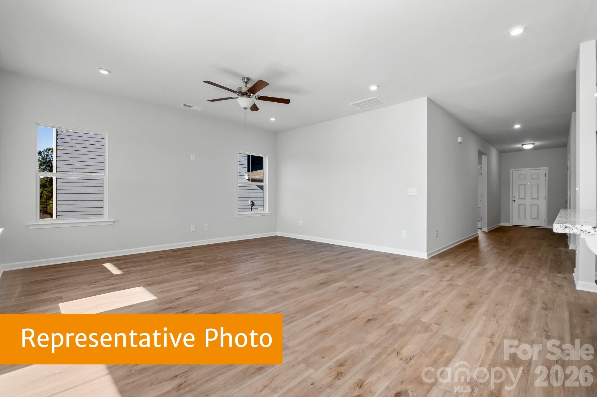 6352 Busch Way Midland, NC 28107 - Photo 10 of 27 a view of kitchen and empty room with wooden floor