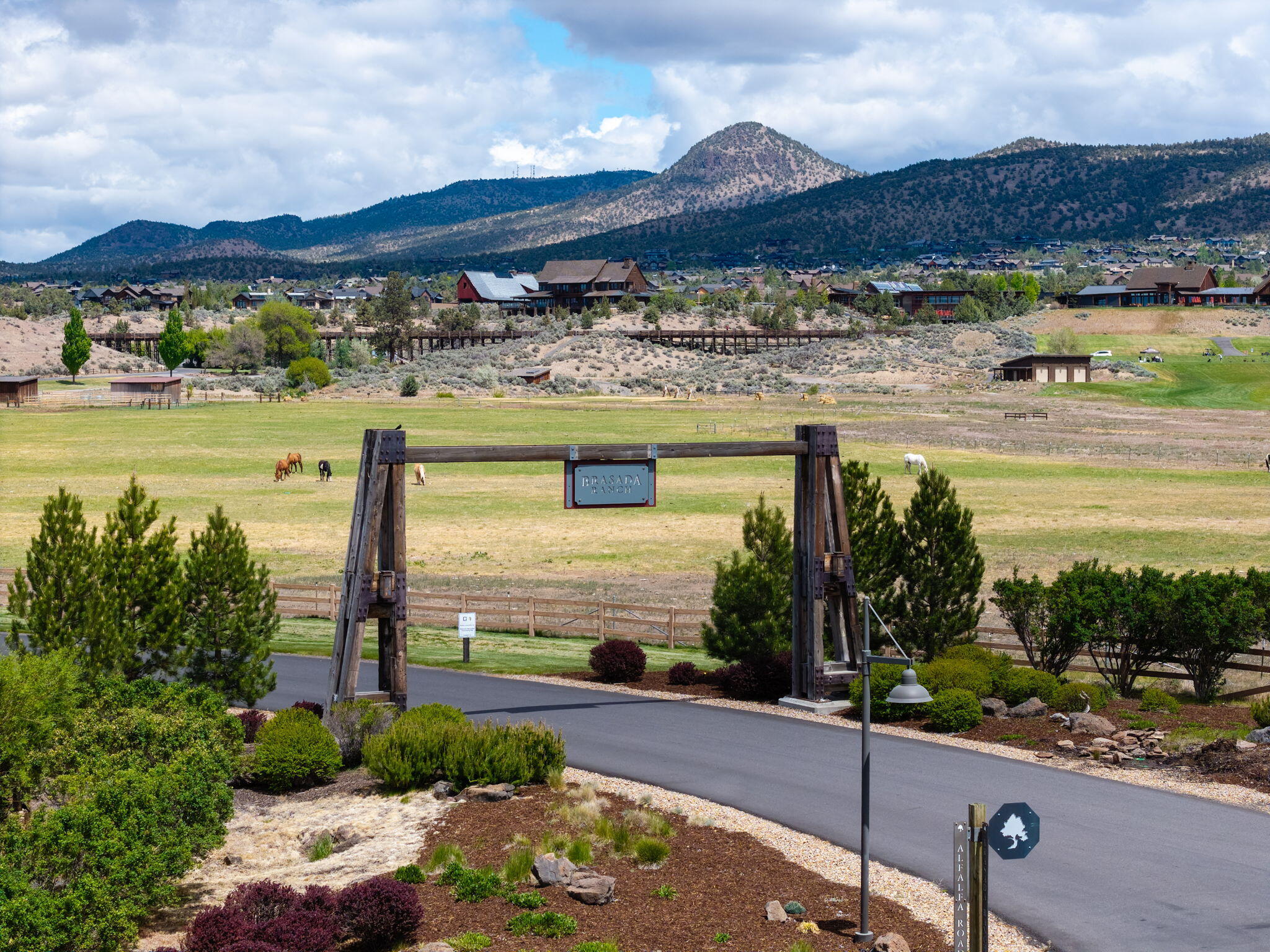 16181 South W Brasada Ranch Road, Unit 115 Powell Butte, OR 97753 - Photo 23 of 25 a front view of a house with a yard and mountain view in back