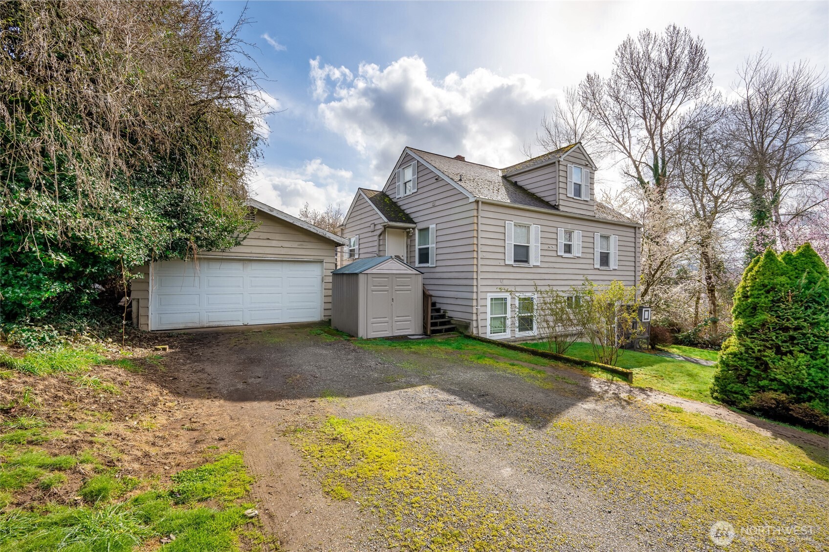 412 Southwest 4th Place Renton, WA 98057 - Photo 2 of 21 a front view of a house with a yard and garage