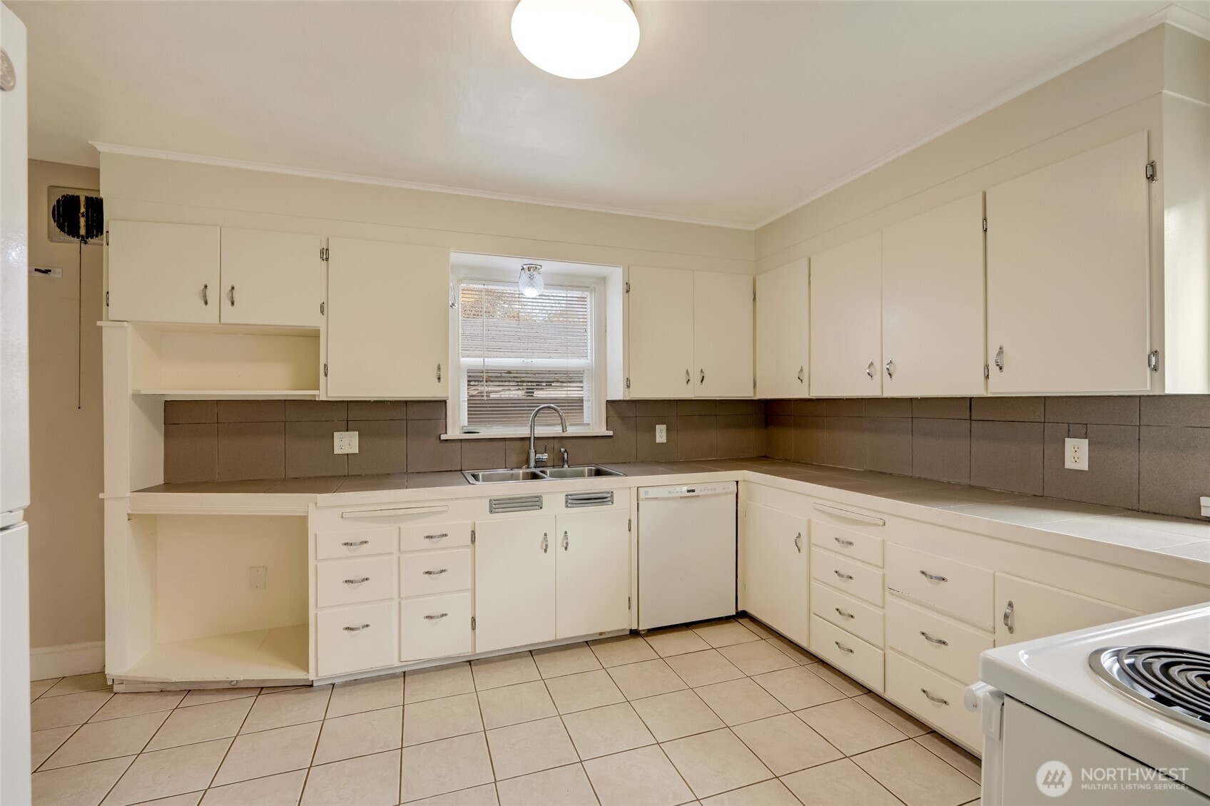 412 Southwest 4th Place Renton, WA 98057 - Photo 8 of 21 a kitchen with white cabinets appliances and a sink