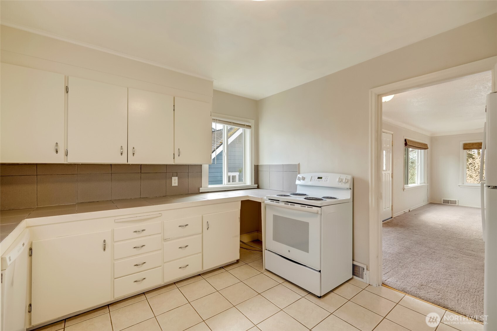 412 Southwest 4th Place Renton, WA 98057 - Photo 10 of 21 a kitchen with granite countertop white cabinets and white appliances