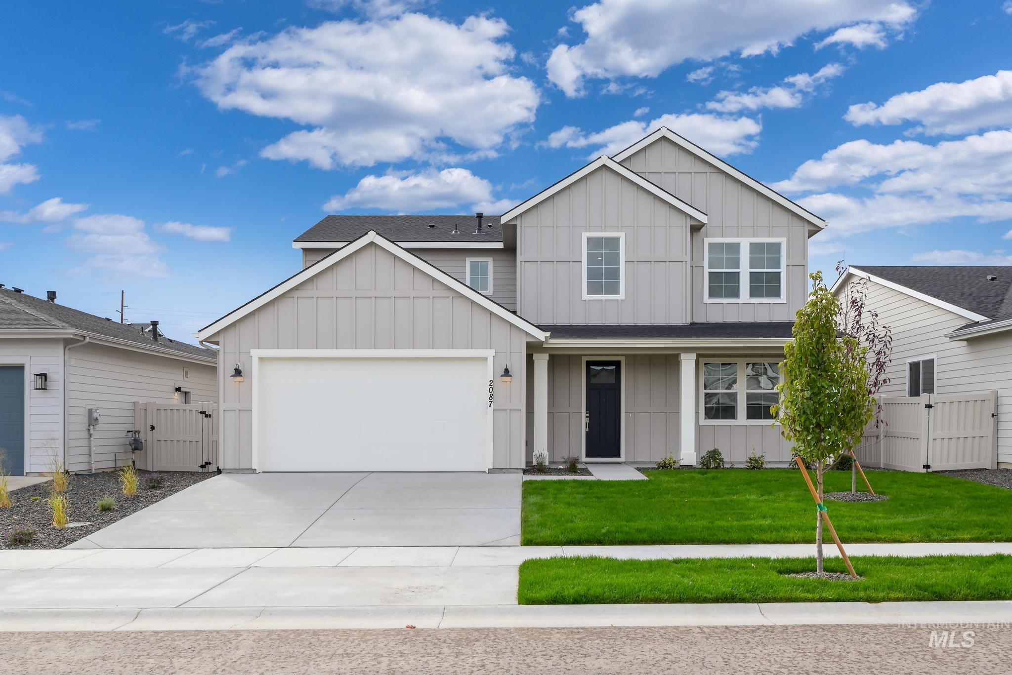 2087 West Gelding Street Middleton, ID 83644 - Photo 1 of 41 View of front facade featuring board and batten siding, a gate, concrete driveway, and an attached garage
