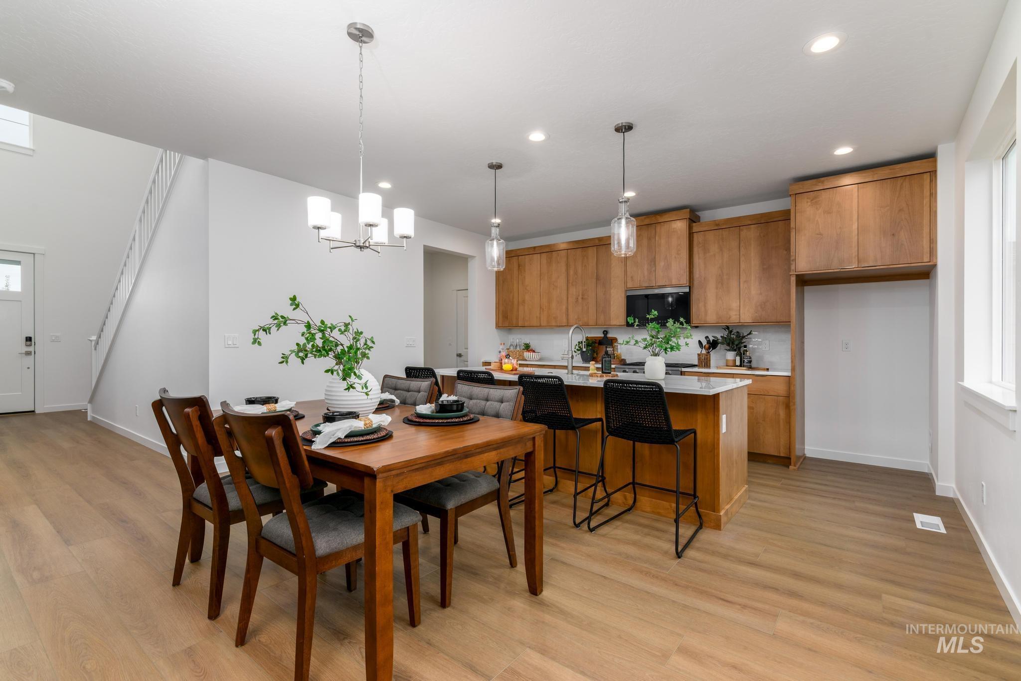 2087 West Gelding Street Middleton, ID 83644 - Photo 11 of 41 Dining space featuring light wood-style flooring, recessed lighting, and a chandelier