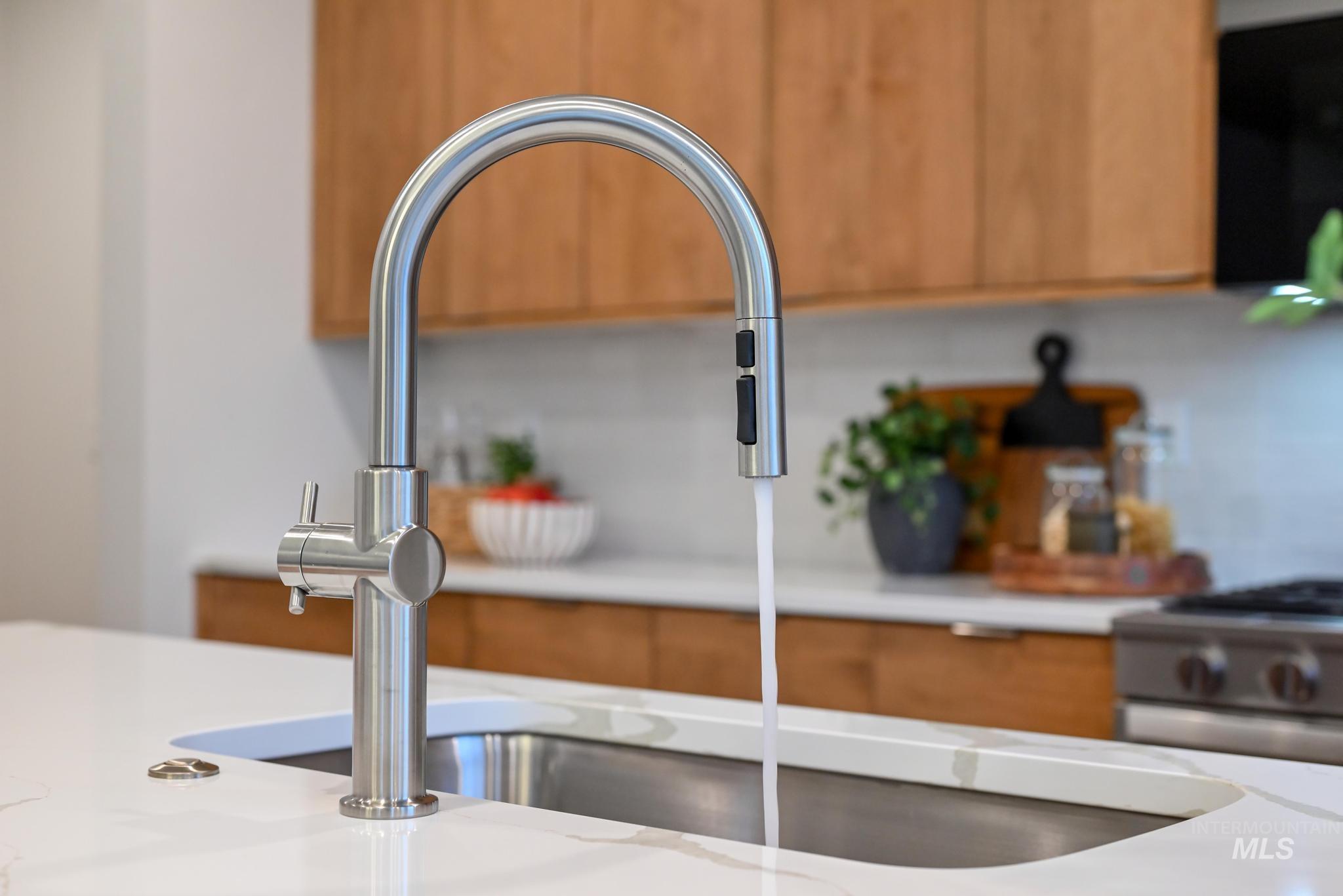 2087 West Gelding Street Middleton, ID 83644 - Photo 17 of 41 Kitchen view of brown cabinets, stainless steel range with gas cooktop, and black microwave