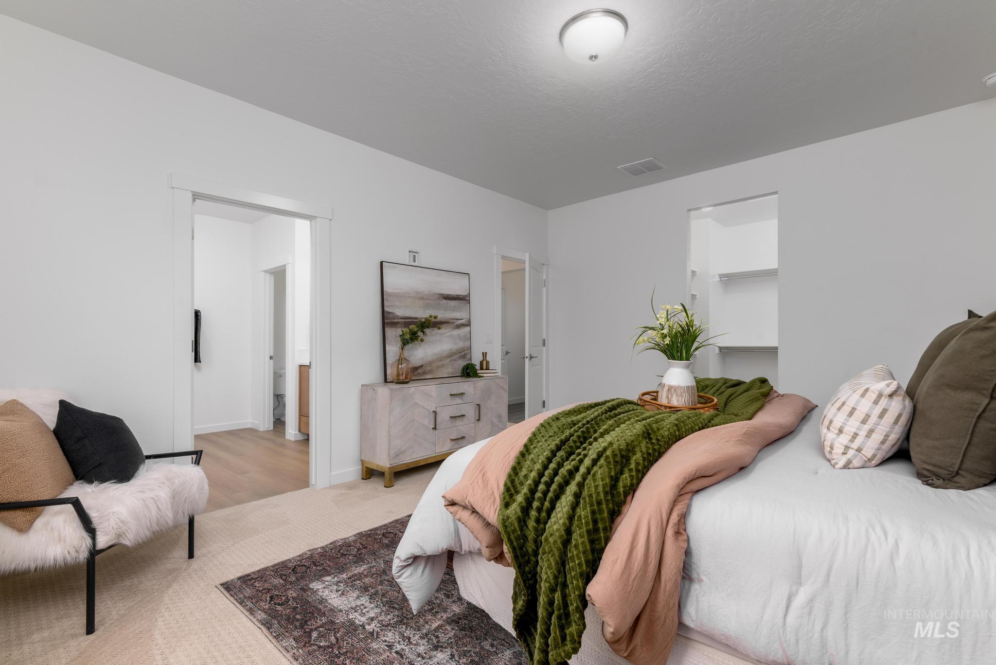 2087 West Gelding Street Middleton, ID 83644 - Photo 20 of 41 Bedroom featuring a walk in closet and a textured ceiling