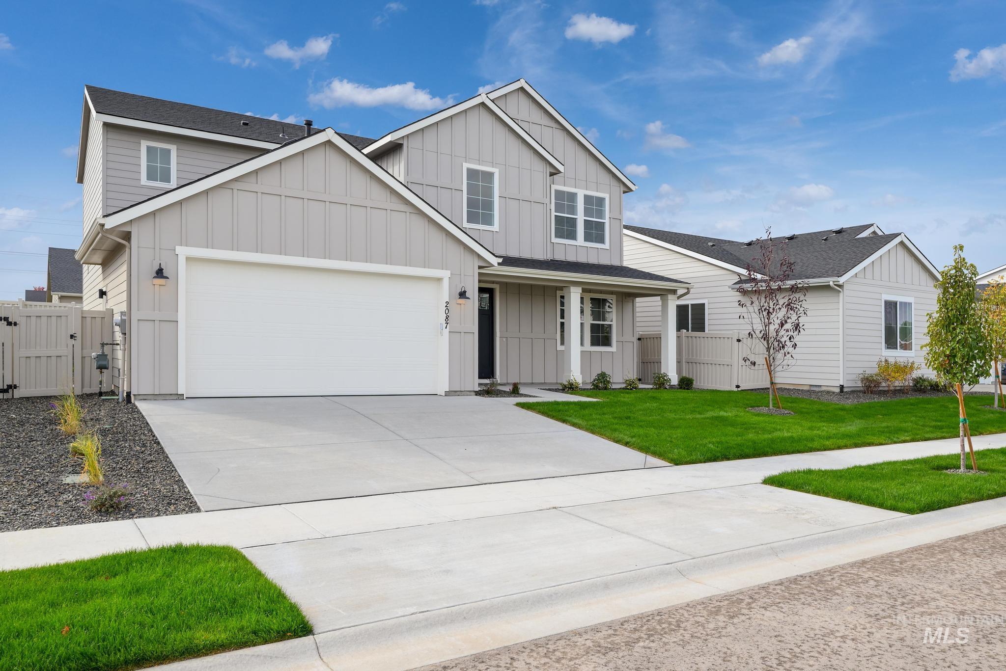 2087 West Gelding Street Middleton, ID 83644 - Photo 2 of 41 View of front of house with board and batten siding, concrete driveway, a gate, and a porch