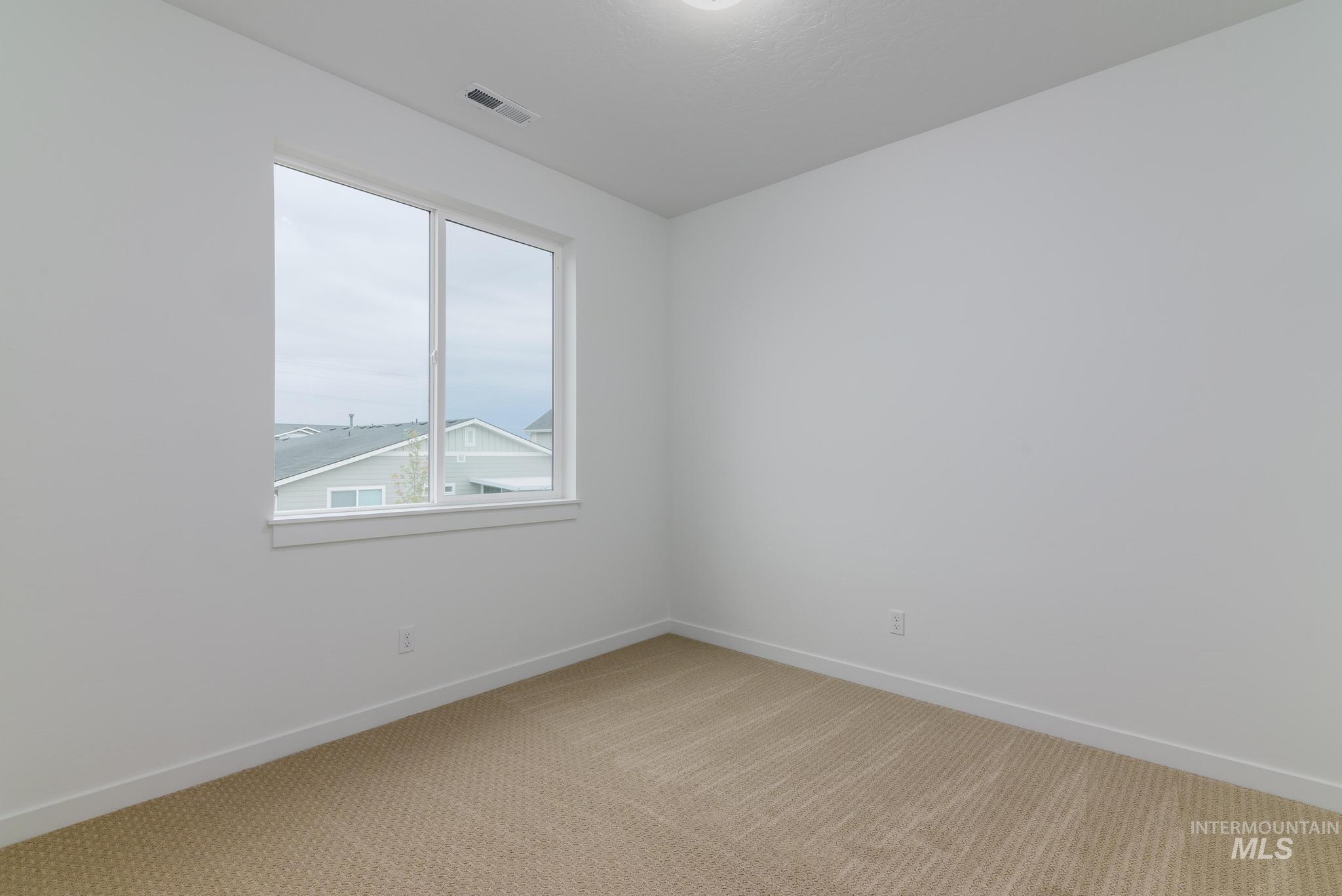 2087 West Gelding Street Middleton, ID 83644 - Photo 24 of 41 Empty room with light carpet and baseboards