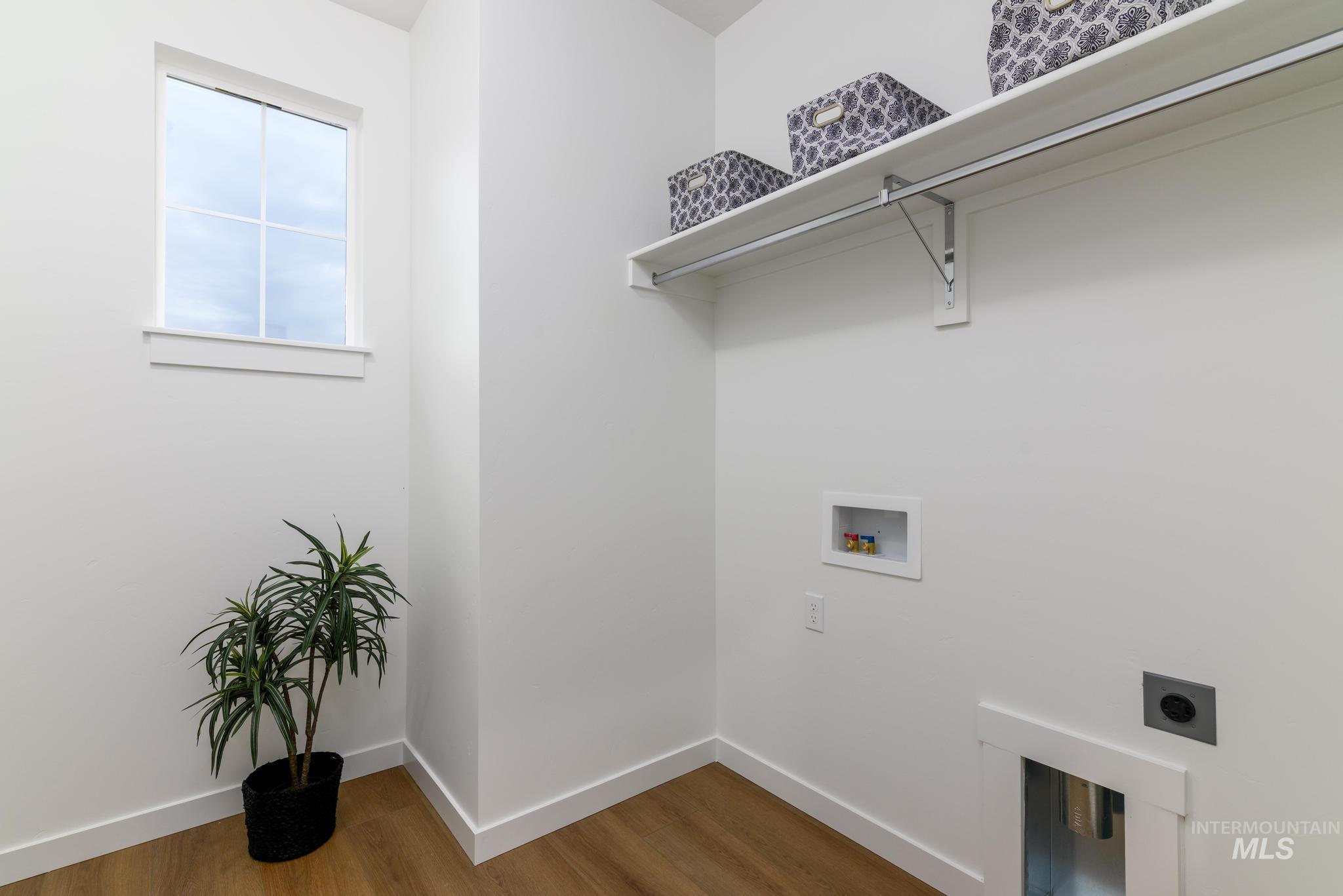 2087 West Gelding Street Middleton, ID 83644 - Photo 27 of 41 Laundry room featuring wood finished floors, hookup for a washing machine, and electric dryer hookup