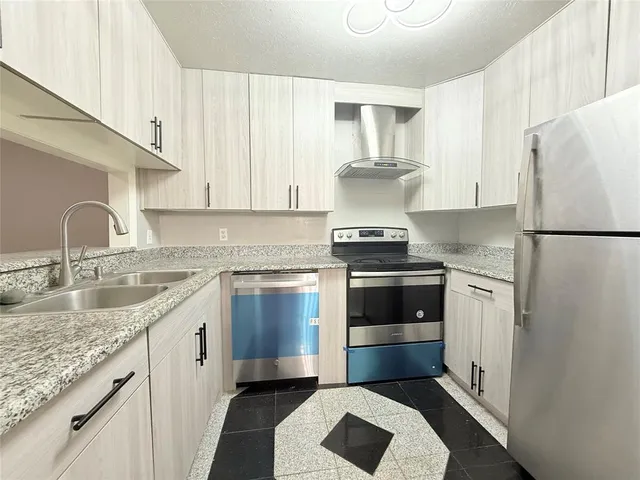 a kitchen with a sink and a refrigerator