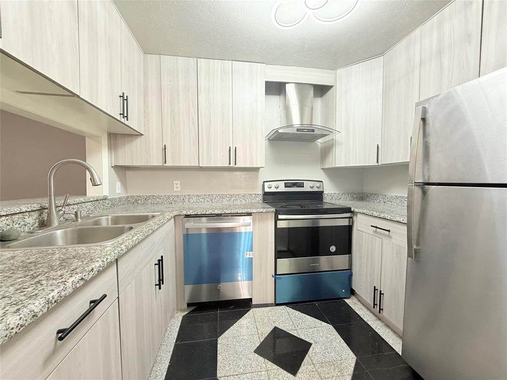 a kitchen with a sink and a refrigerator