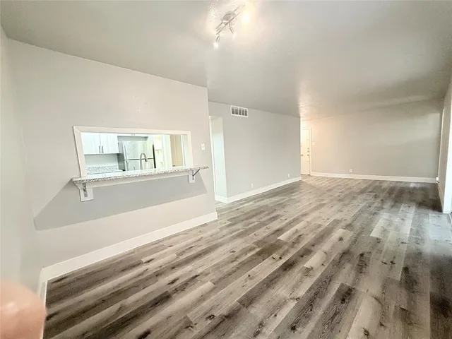 a view of wooden floor and windows in a room