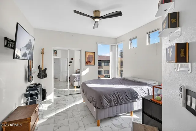 a bedroom with a bed couch and a window