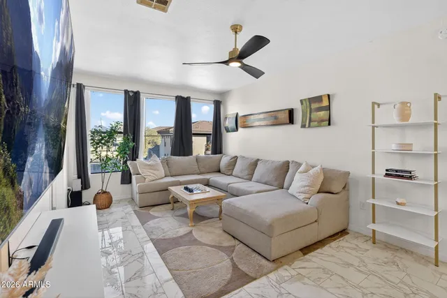a living room with furniture and a large window