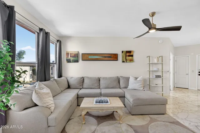 a living room with furniture and a large window