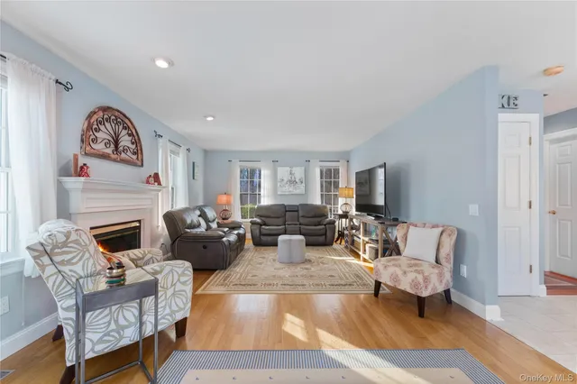 a living room with furniture or couch and a wooden floor