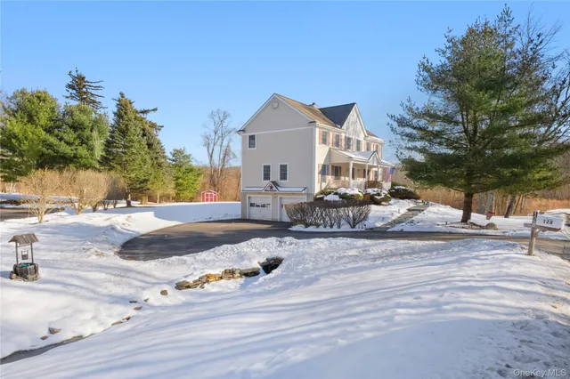 a view of a house with a snow in the background