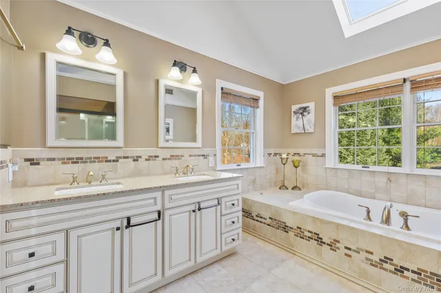 a bathroom with bathtub sink and window