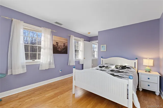 a bathroom with a granite countertop sink a mirror and a bathtub