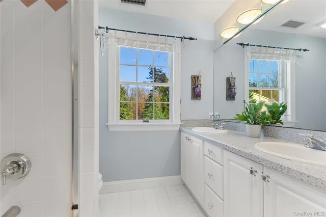 a view of empty room with wooden floor and window