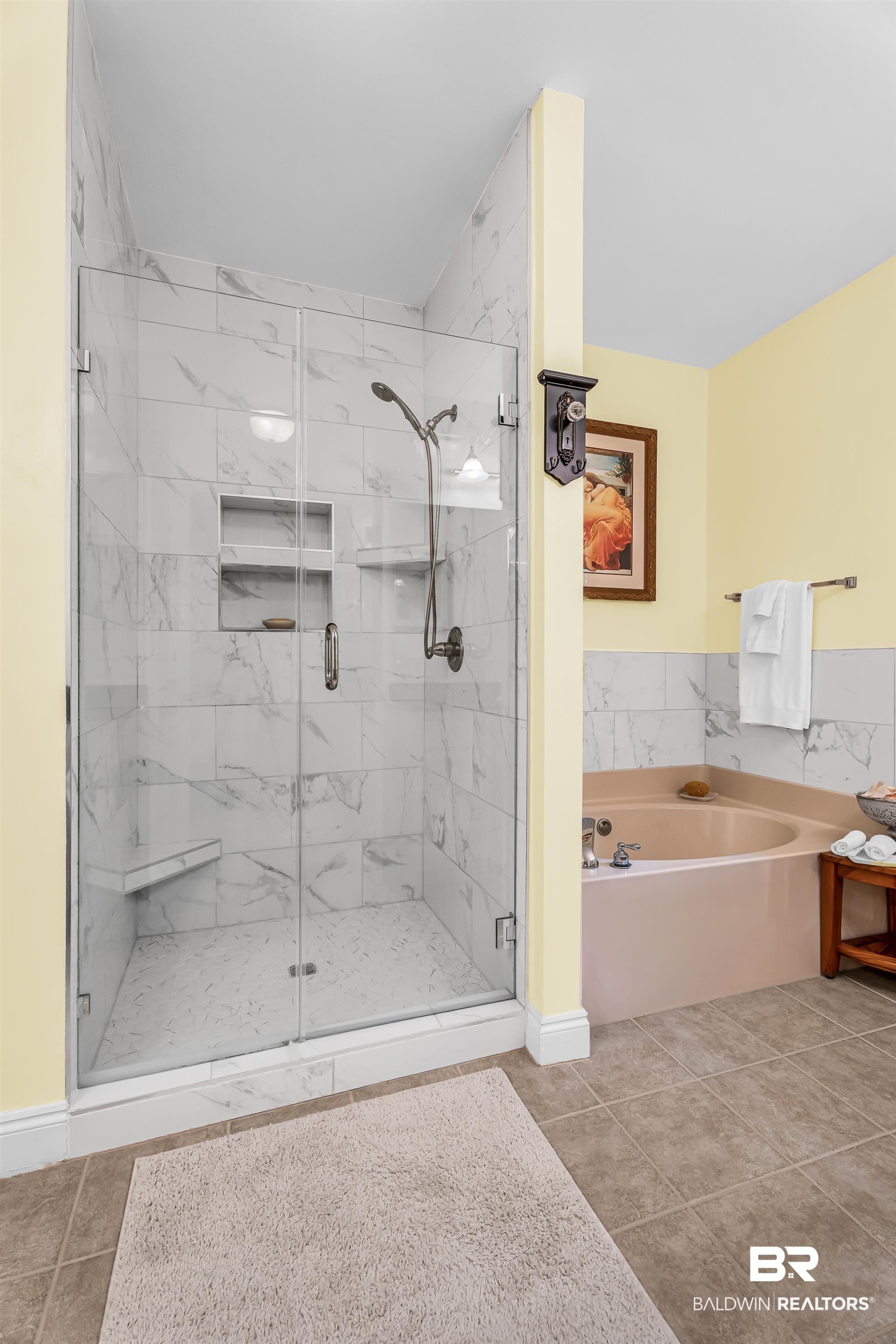7014 Blakeley Road Daphne, AL 36527 - Photo 39 of 45 Walk-in shower with clear glass enclosure, a built-in bench, and dual recessed shelving