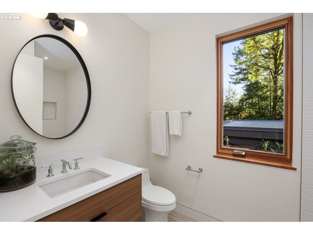 4311 Southwest 36th Place Portland, OR 97221 - Photo 39 of 48 a bathroom with a toilet a sink and a mirror