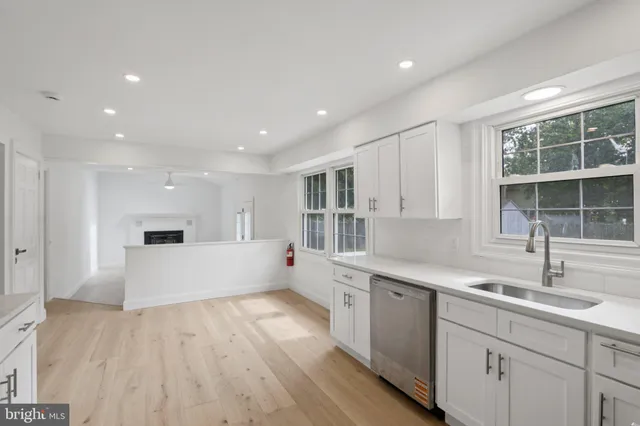 a large kitchen with kitchen island a sink stainless steel appliances and cabinets