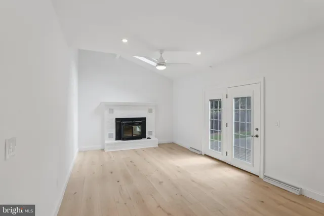 a view of empty room with wooden floor