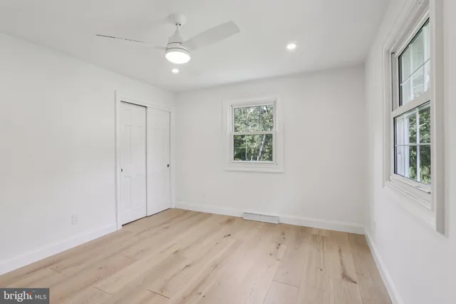 an empty room with a empty space and windows